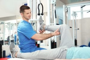 physiotherapist,working,with,patient,in,rehabilitation,center